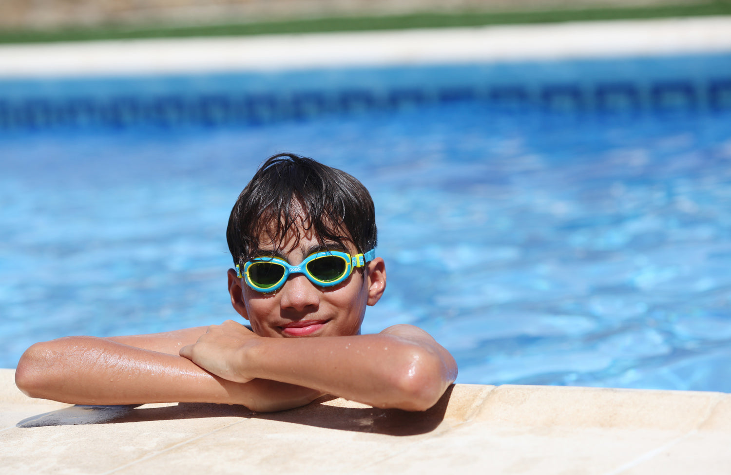 Young Boy Enjoying Swimming Pool with Vazquez Goggz Blue and Yellow Swim Goggles