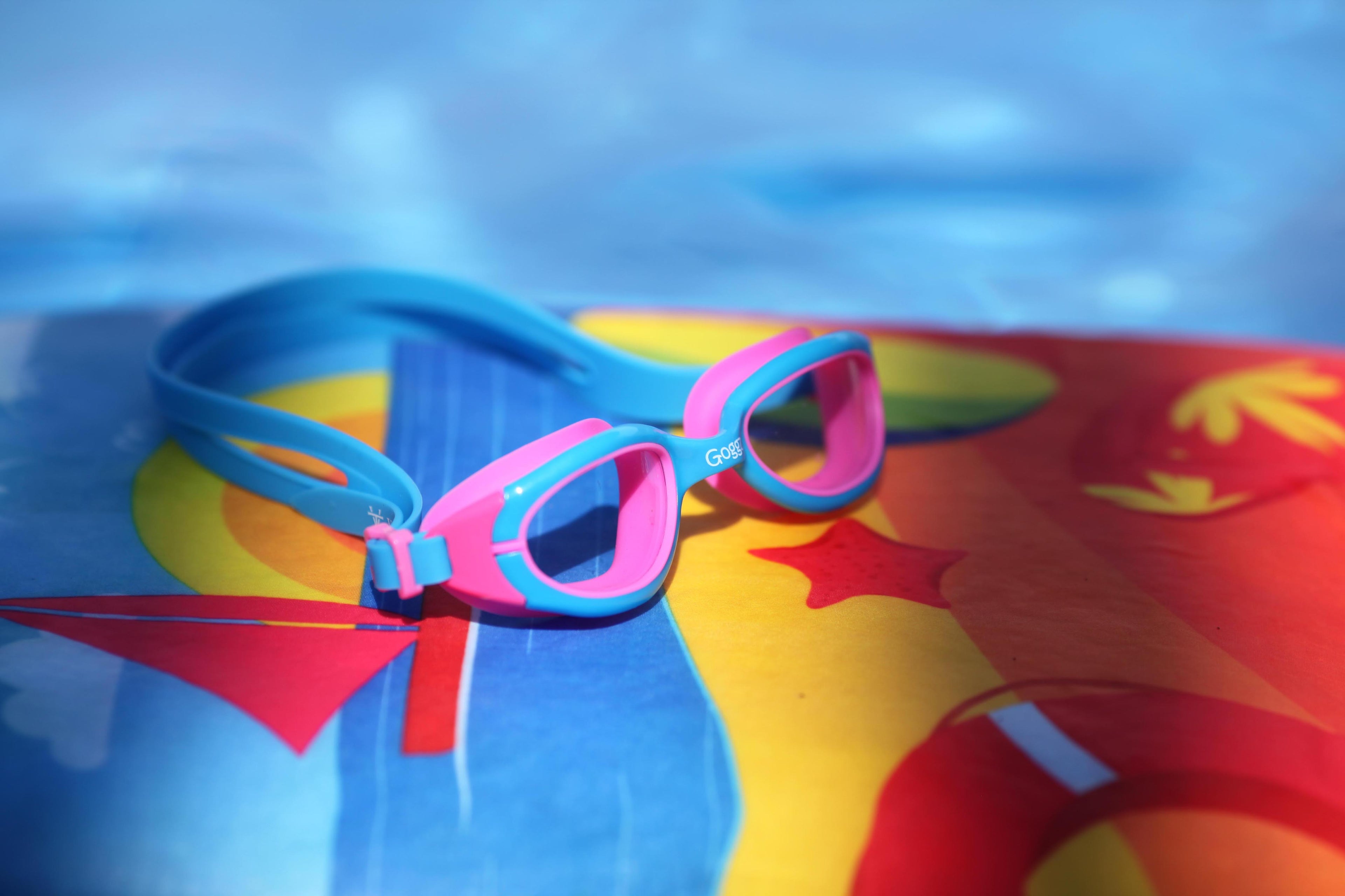 Pink Vazquez Goggz Kids Swim Goggles Floating Gracefully on a Pool - Stylish Swim Eyewear and Goggles